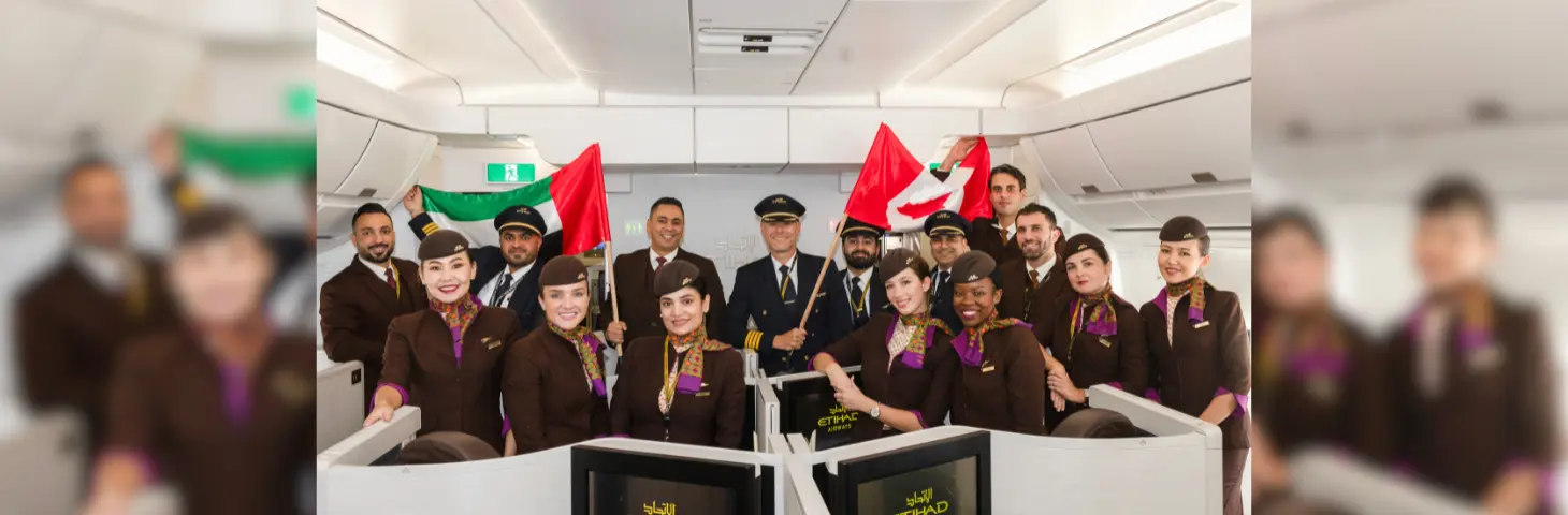 Group of Etihad employees inside the A350 aircraft with an Abu Dhabi and Canada flag