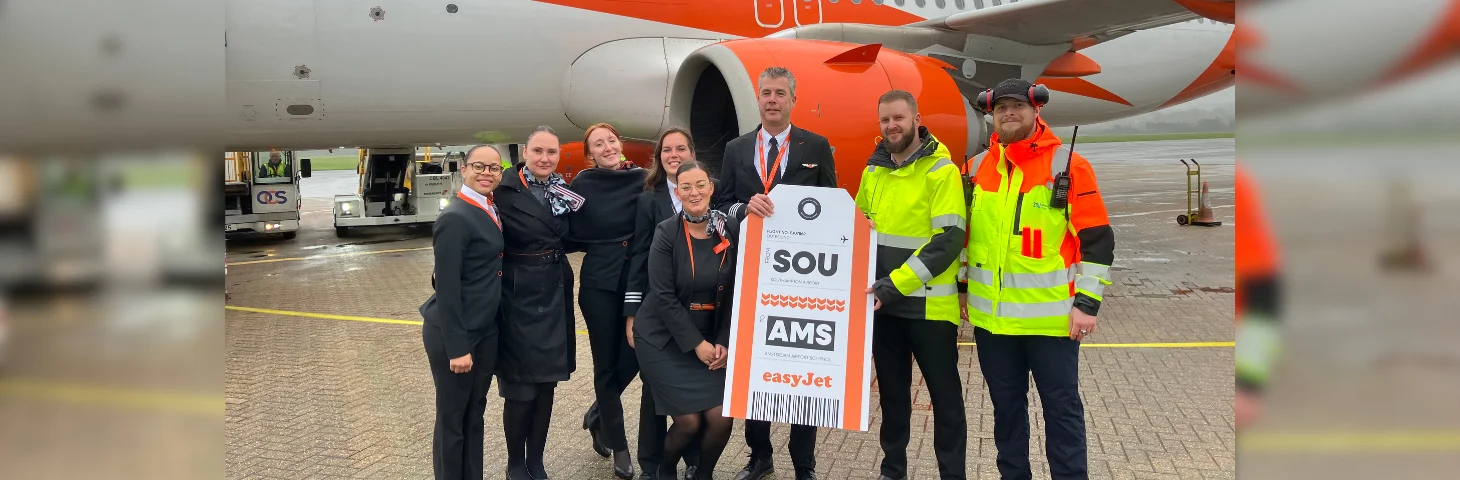 easyJet cabin crew and Southampton Airport ground staff celebrating the launch of the new Southampton to Amsterdam service on the runway.