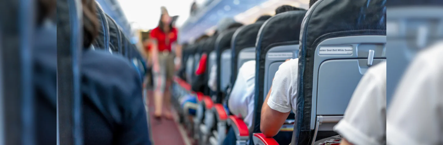 Aeroplane passengers sat in the centre aisle.