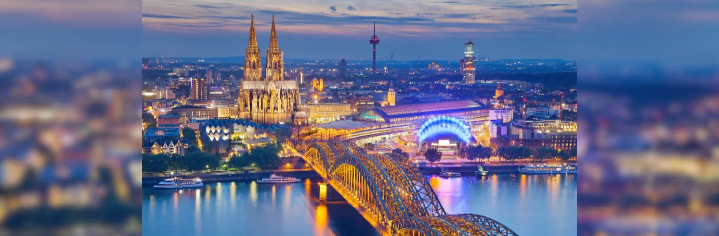 An aerial view of Cologne from over the Rhine at night-time.